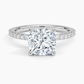 Diamond ring with a large central diamond and smaller stones on the band against a white background